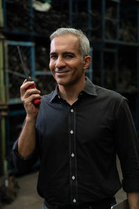 Portrait of smiling man holding camera