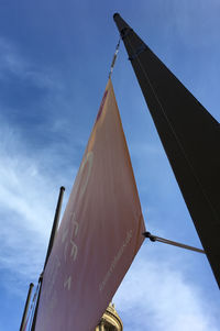 Low angle view of flags against sky