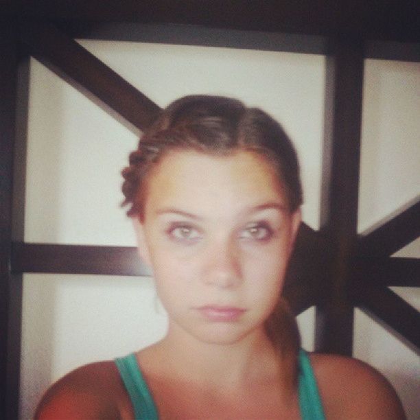 indoors, looking at camera, portrait, young adult, person, lifestyles, headshot, front view, home interior, leisure activity, young women, casual clothing, head and shoulders, contemplation, close-up, smiling