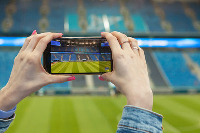 Midsection of man using mobile phone