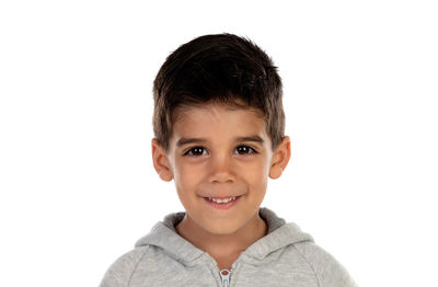 Portrait of smiling boy against white background