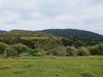 Scenic view of mountains against cloudy sky