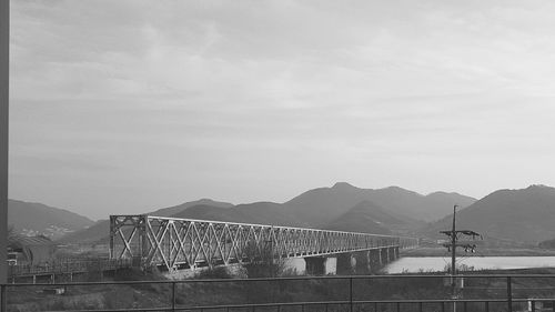 Bridge over mountains against sky