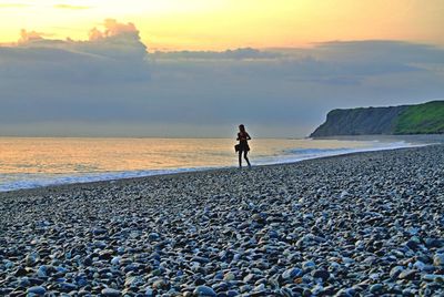 Scenic view of beach at sunset
