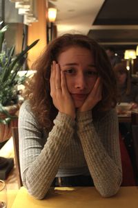 Portrait of teenage girl sitting in restaurant