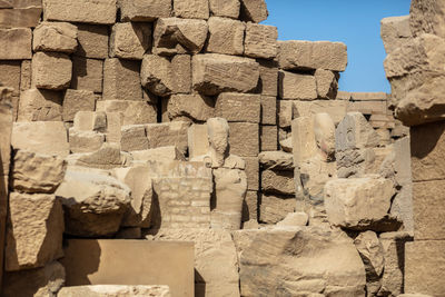 Statues of ancient egyptian pharaohs and gods. various hieroglyphs on the walls.