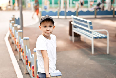 Young teen boy kid playing at a park on playground