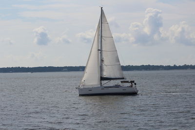 Sailboat sailing on sea against sky