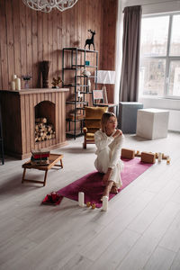 Woman sitting on floor at home