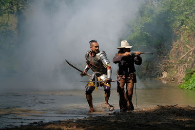 Warriors with weapons in forest