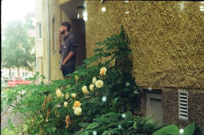 Woman standing by plants