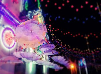 Low angle view of illuminated christmas decorations at night