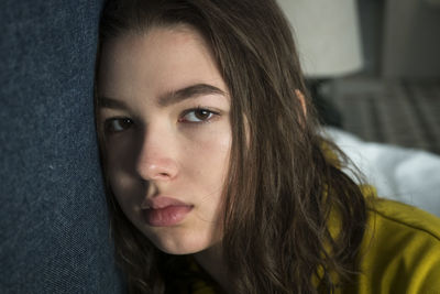 Close-up portrait of a sad young woman at home