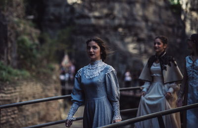 Young women walking by railing