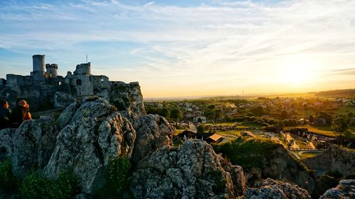 Panoramic view of city buildings against sky during sunset