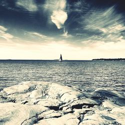 Scenic view of sea against cloudy sky