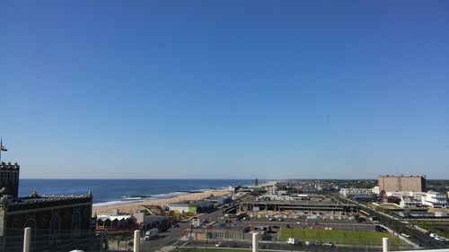 View of cityscape against clear blue sky