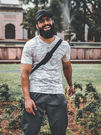 Portrait of smiling young man standing outdoors