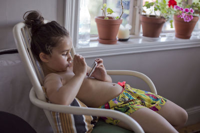 Girl on chair using cell phone