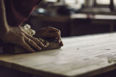 Close-up of hand holding table