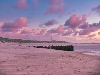 Scenic view of beach against sky during sunset