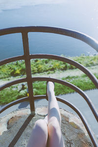 Low section of young woman on railing at observation point