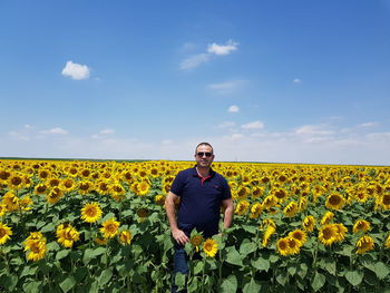 Full length of sunflower in field against sky