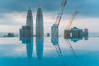 Digital composite image of modern buildings against sky