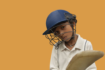 Portrait of boy wearing hat against gray background