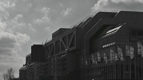 Low angle view of building against cloudy sky