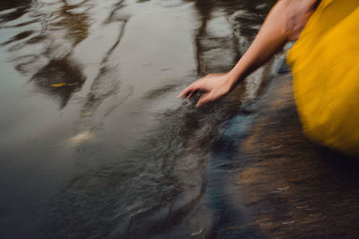 Blurred motion of person hand on wet land