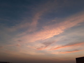 Low angle view of dramatic sky during sunset