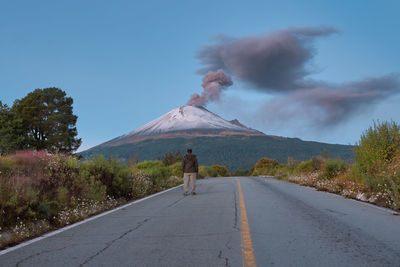 Rear view of man on road against sky