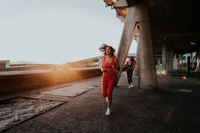 Full length of woman running on road