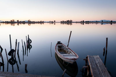 Boats moored in sea against clear sky