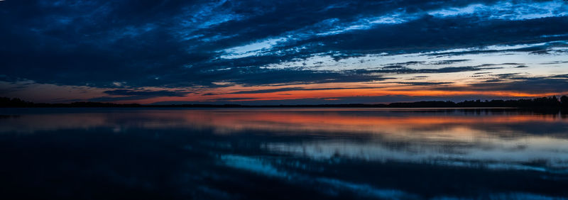 Scenic view of lake against romantic sky at sunset