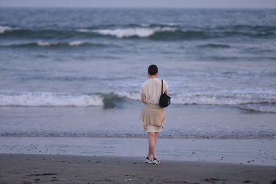 Rear view of people on beach