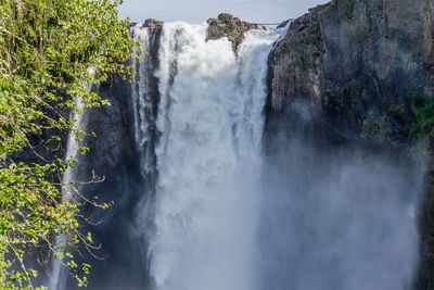 Water over the edge of snoqualmie falls in washington state.