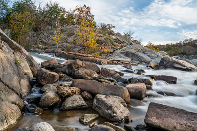 View of stream flowing through rocks