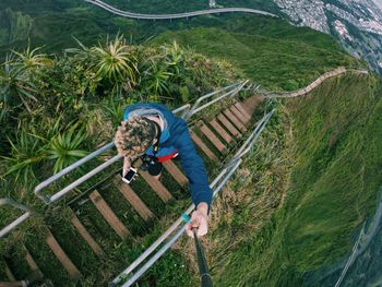 High angle view of man on haiku stairs at oahu