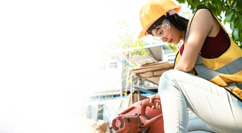 Woman sitting on mobile phone