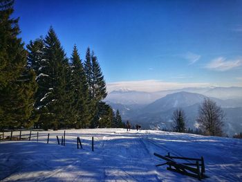 Snow covered landscape against sky