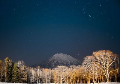 Scenic view of mountains against sky at night