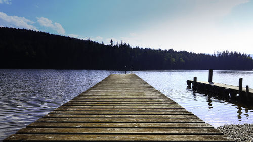 Pier over lake against sky