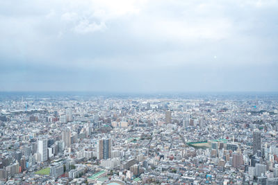 High angle view of city buildings against sky