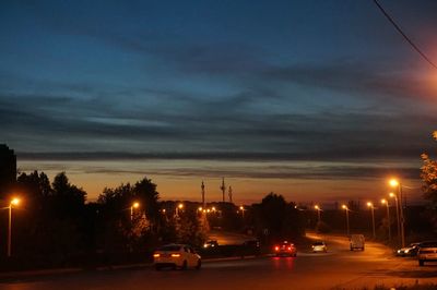 Traffic on road at sunset