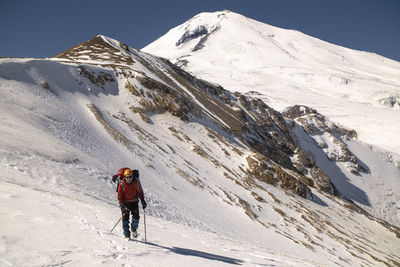 Full length of person on snowcapped mountain against sky