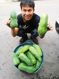 High angle portrait of smiling man selling papaya