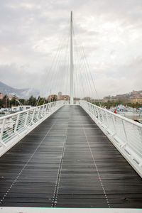 View of suspension bridge against cloudy sky