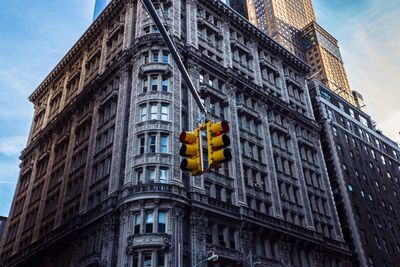 Low angle view of road signal against building